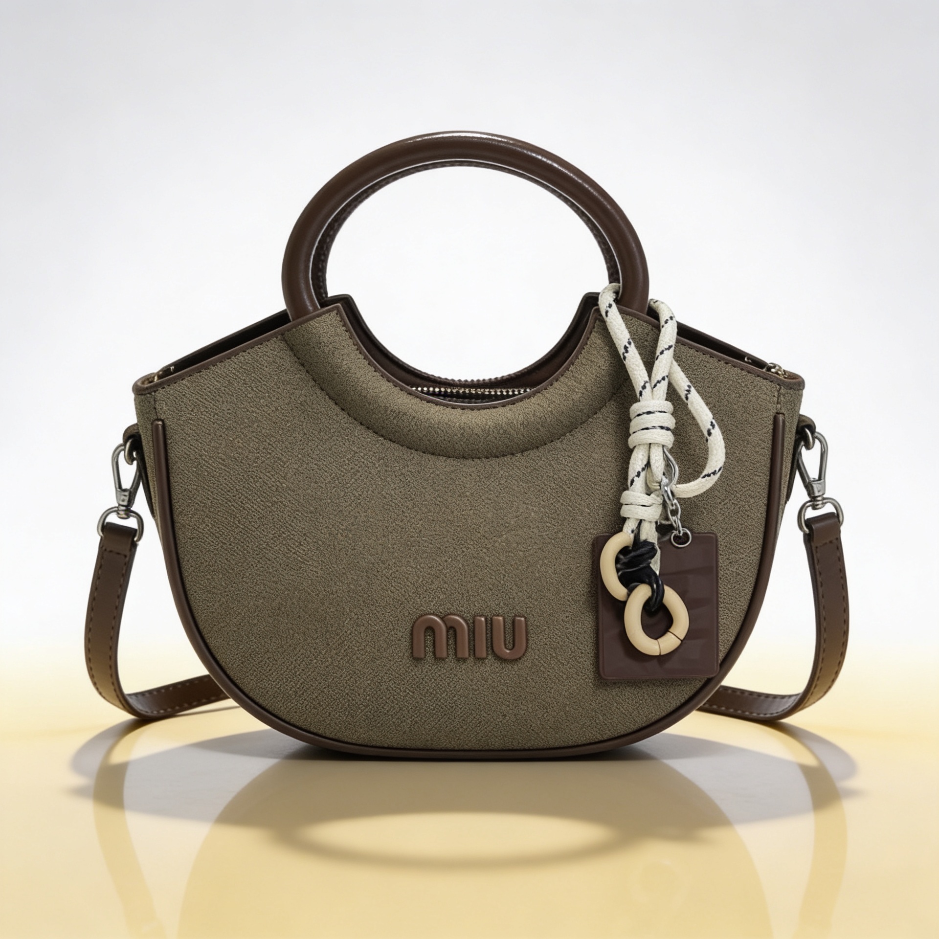Luxury olive green canvas half-moon handbag with circular leather handles and detachable crossbody strap for women