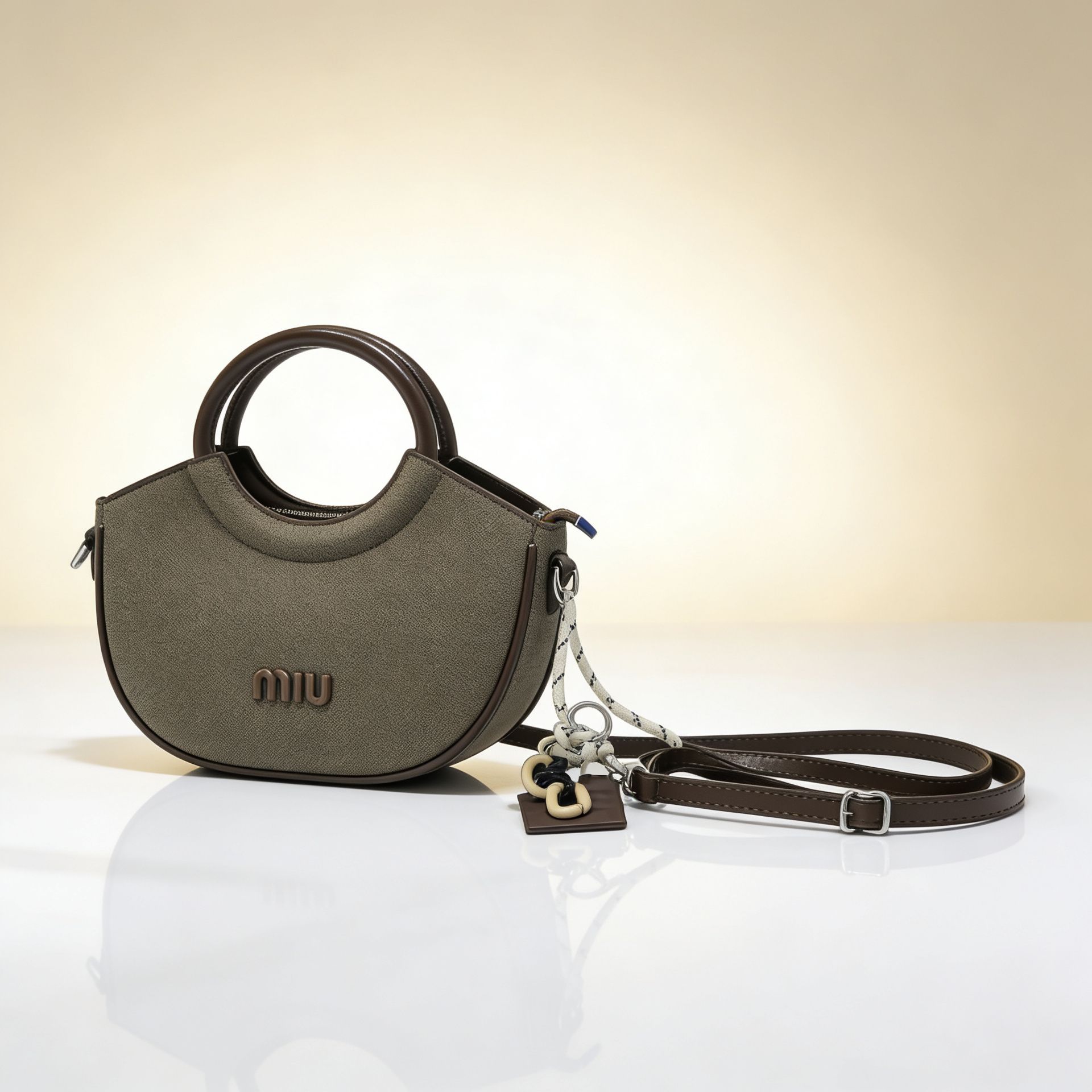 Luxury olive green canvas half-moon handbag with circular leather handles and detachable crossbody strap for women